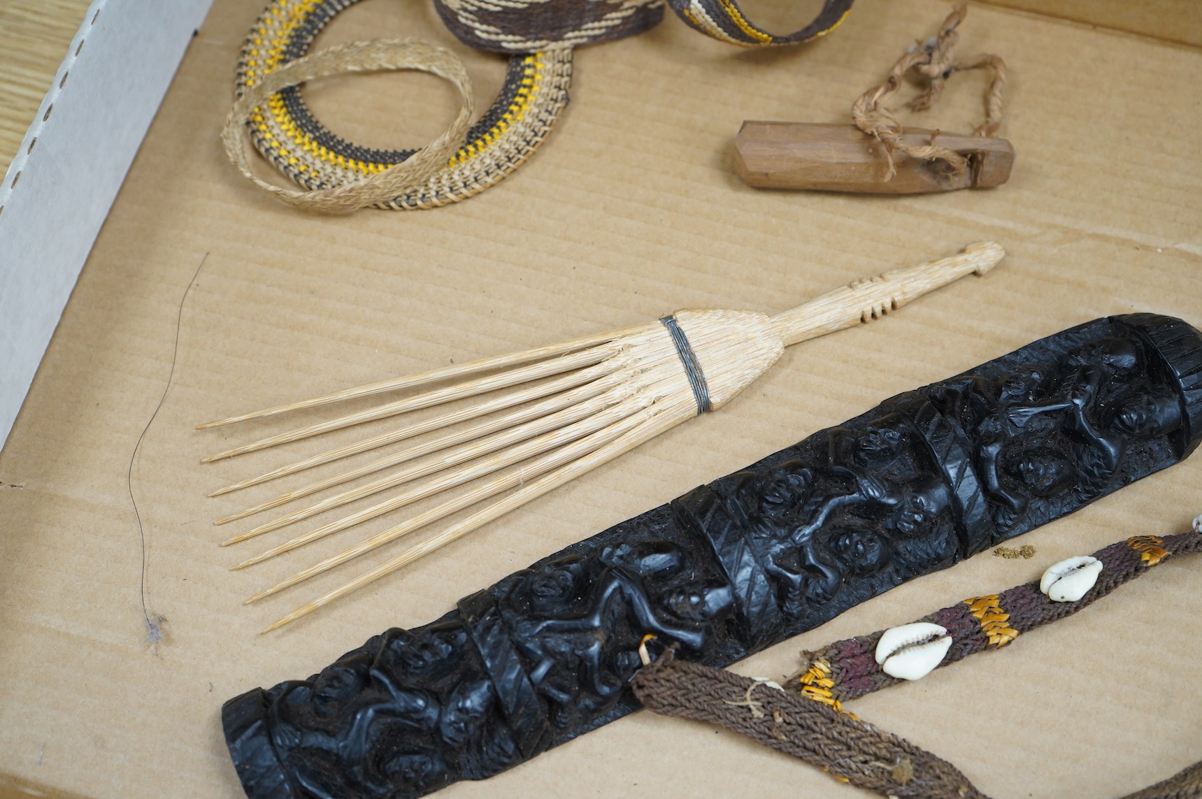 A collection of tribal carvings, straw bags, an abacus- 29cm wide and boomerang